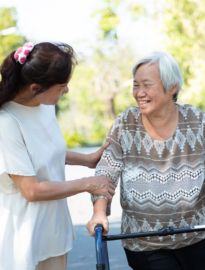 Woman guiding the smiling elderly lady